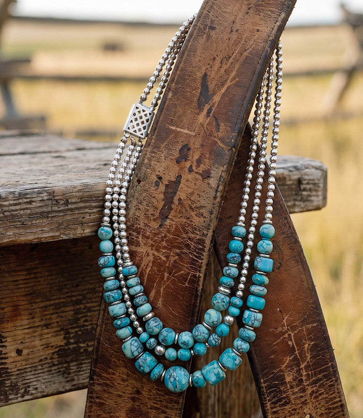 Multi strand turquoise necklace with silver accents and layered beads