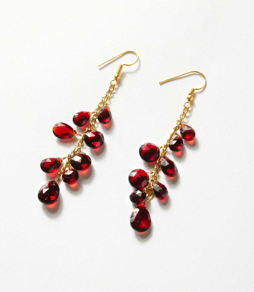 Cascading gemstone earrings with burgundy synthetic garnet on gold-plated chains and gold hook closures