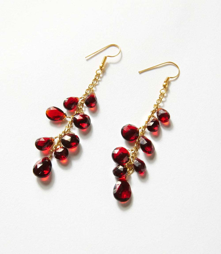 Cascading gemstone earrings with burgundy synthetic garnet on gold-plated chains and gold hook closures