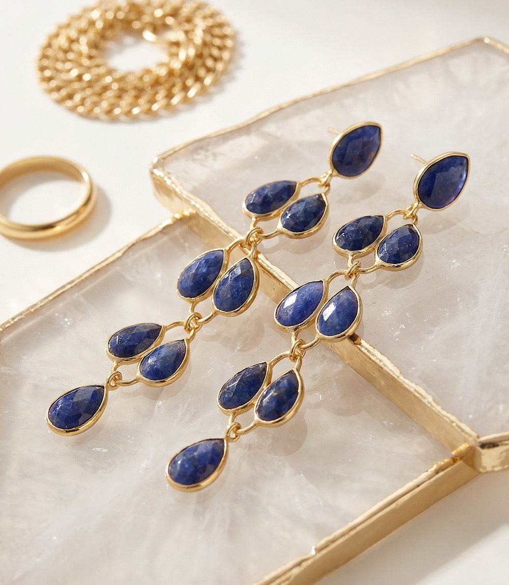 Gold plated feather drop gemstone earrings with blue stones, 2.75 inches long