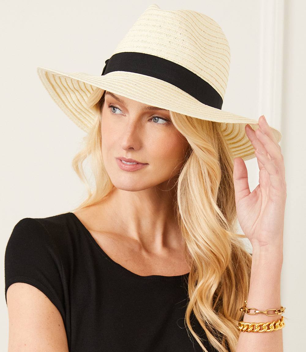 Straw Panama Hat with black band worn by woman with blonde hair and black top