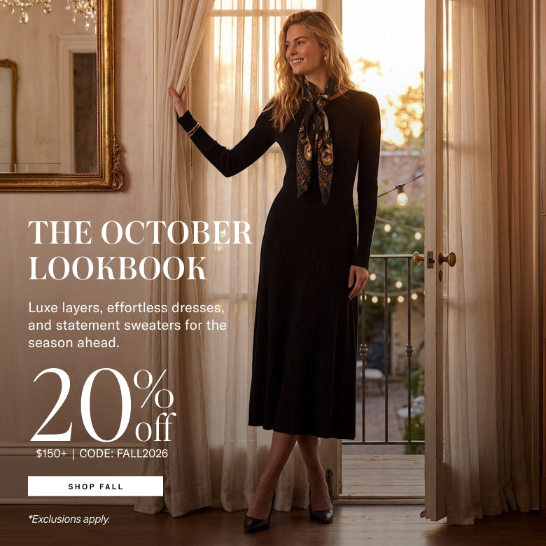 A woman stands in a sunlit room by open curtains and a balcony door, wearing a long black dress with a patterned neck scarf. Large promotional text on the left reads 'THE OCTOBER LOOKBOOK' and '20% off'.