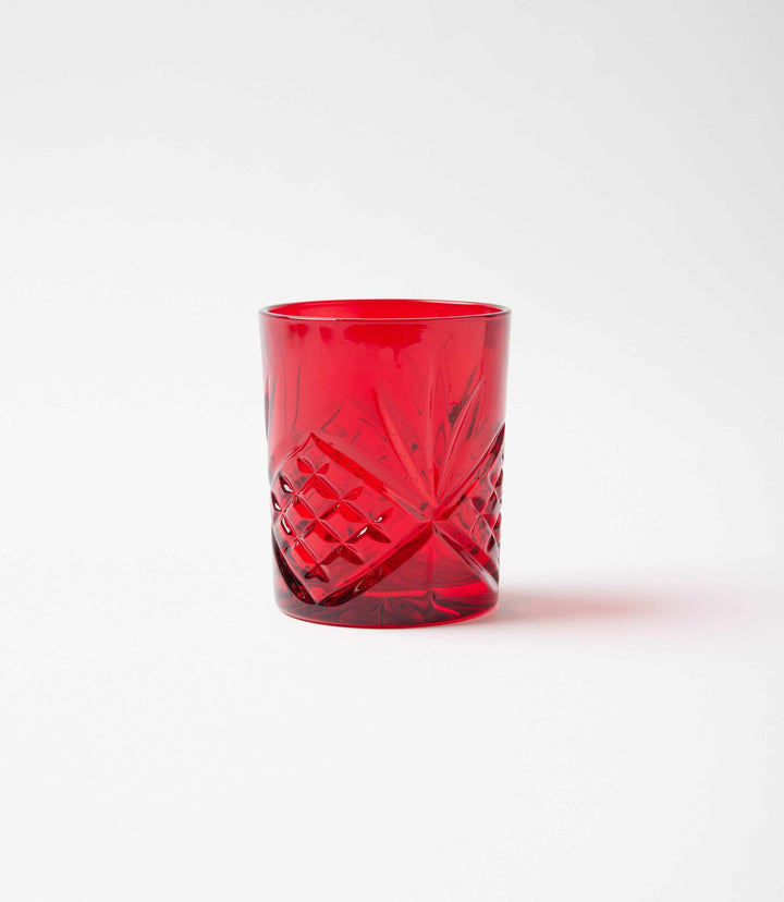 Red crystal drinking glass with intricate cut-crystal pattern, elegant and high-quality.