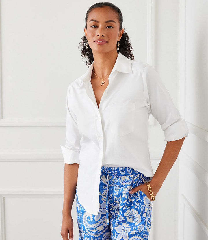Woman wearing white ruched sleeve button-up shirt with pearl buttons and front pocket