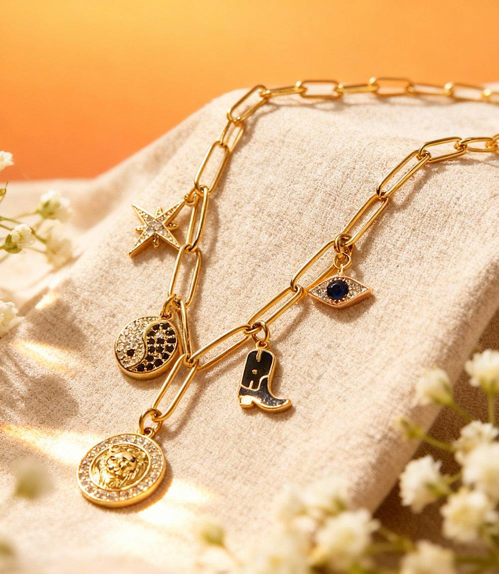 Gold Charm Station Necklace with five unique 16K plated charms on fine chain, hypoallergenic and stylish accessory