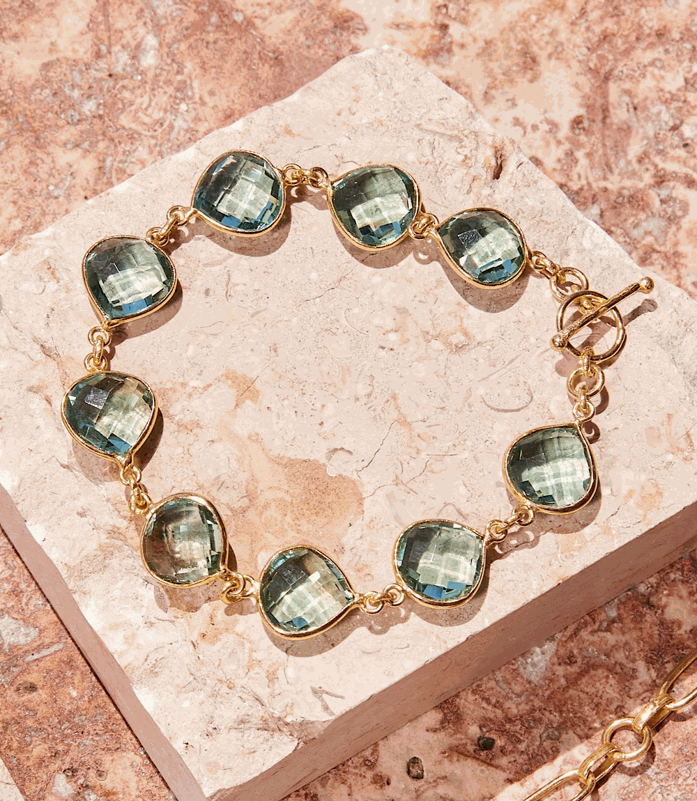 Aqua Quartz Bracelet featuring faceted aquamarine stones set in gold, 7-inch length with extender, elegant and versatile design.