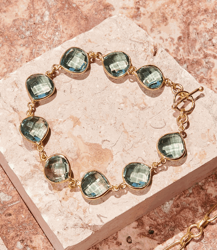 Aqua Quartz Bracelet featuring faceted aquamarine stones set in gold, 7-inch length with extender, elegant and versatile design.