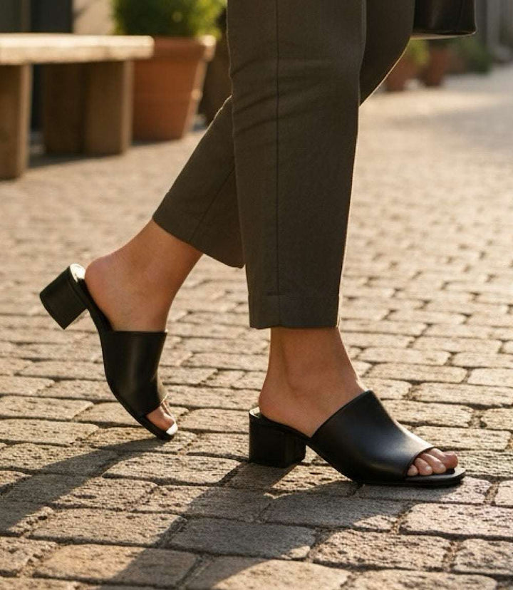 Black Pepper Mid Heel Sandals with square toe and 2-inch heel on cobblestone street