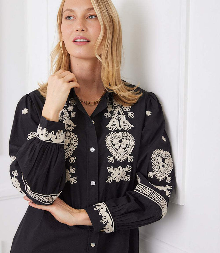 Black shirtdress with cream rope-stitch embroidery and blouson sleeves with embroidered cuffs