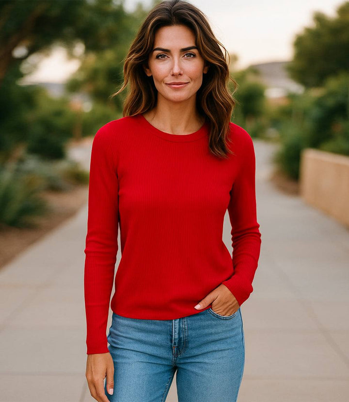 Woman wearing a red long sleeve ribbed crewneck top with slim fit and set-in sleeves outdoors