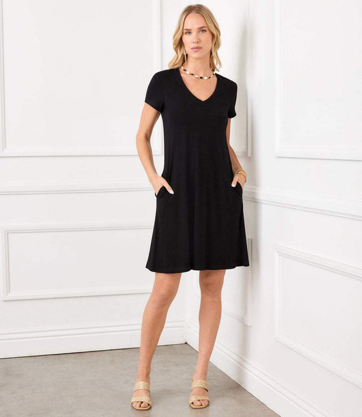 Woman wearing black Quinn V-Neck pocket dress with short sleeves and relaxed fit