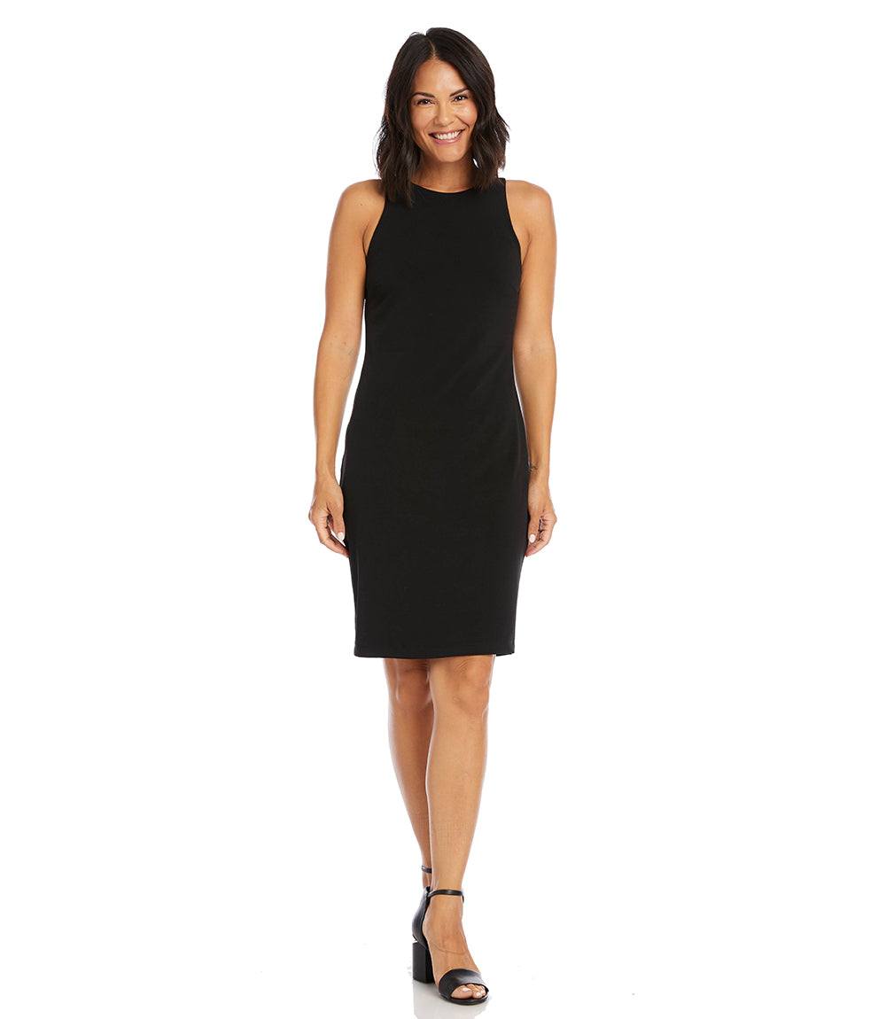 Woman wearing a sleeveless black wrinkle-resistant travel jersey dress with back zipper and knee-length hem