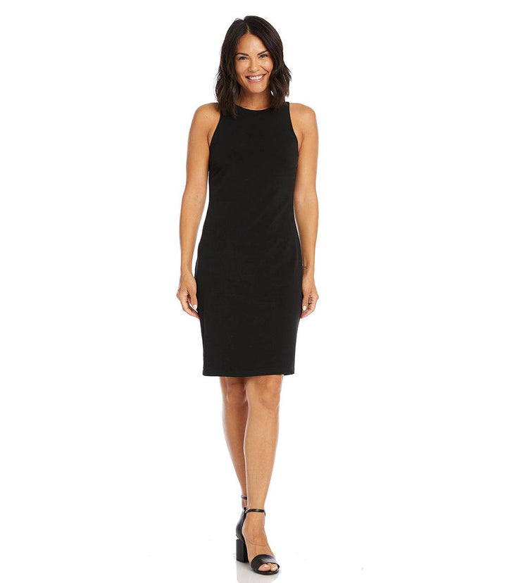 Woman wearing a sleeveless black wrinkle-resistant travel jersey dress with back zipper and knee-length hem