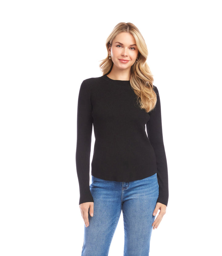 Woman wearing black ribbed crewneck sweater with fitted long sleeves and blue jeans on white background