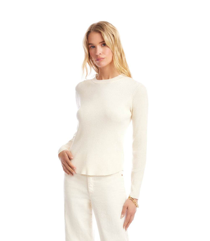 Woman wearing a fitted white ribbed crewneck sweater with long sleeves and a clean silhouette.