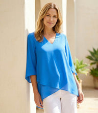 Bracelet Sleeve Asymmetric Top in silky crepe with flare sleeves and layered asymmetrical hem