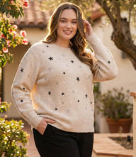 Plus size black sweater with embroidered stars, crew neck, long sleeves, and ribbed cuffs and hem.