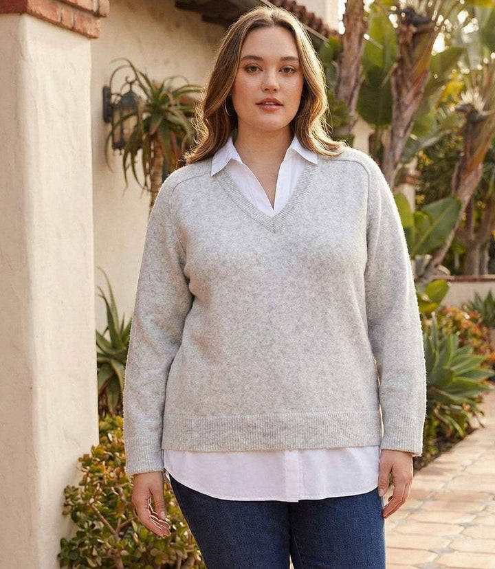 Plus size layered sweater with V-neck, shirt collar, raglan sleeves, and faux-layered shirttail hem
