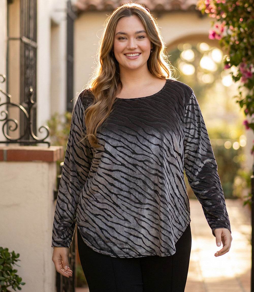 Plus size long sleeve velvet burnout top with zebra pattern and shirttail hem