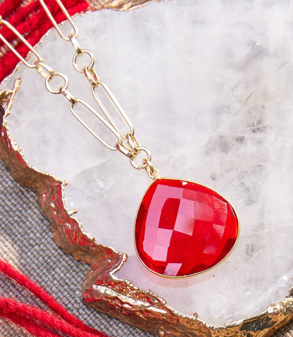 Ruby quartz pendant necklace with faceted red stone and gold-plated elongated-link chain