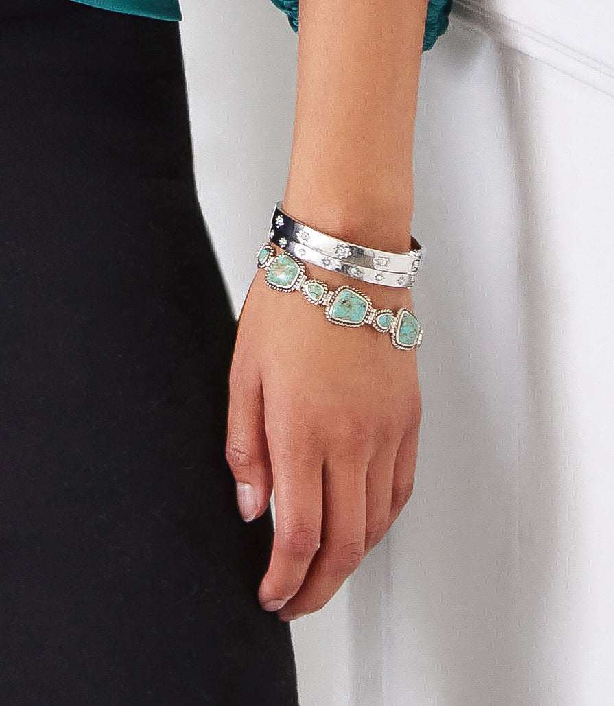 Turquoise bracelet with sterling silver and twisted wire rope worn on wrist