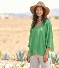 Silky crepe Bracelet Sleeve Asymmetric Top with V-neck, flare sleeves, and layered asymmetrical hem
