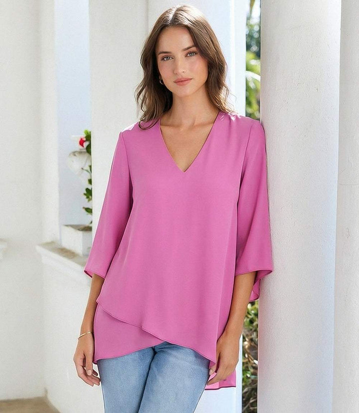 Bracelet Sleeve Asymmetric Top in silky crepe with V-neck, flare sleeves, and layered asymmetrical hem.