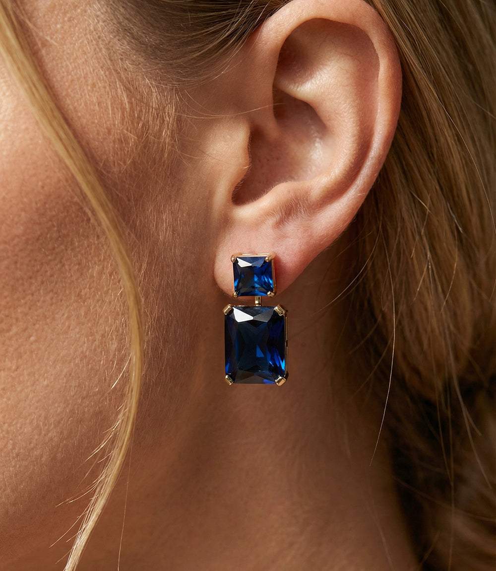 Princess cut drop earrings with stacked sapphire blue cubic zirconia set in gold over brass