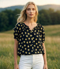 Petite size puff sleeve peasant top with black and yellow floral print, raglan sleeves, and front button closure