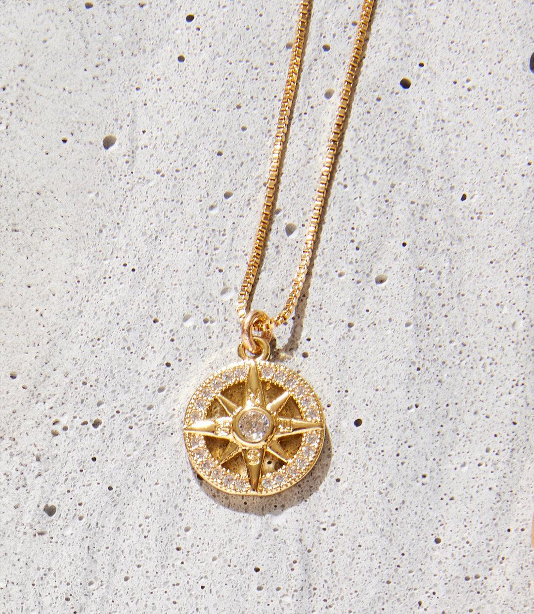 Cutout Sunburst Necklace in 14k and 18k gold fill with intricate sunburst pendant and sparkling center stone on a 16-inch chain.
