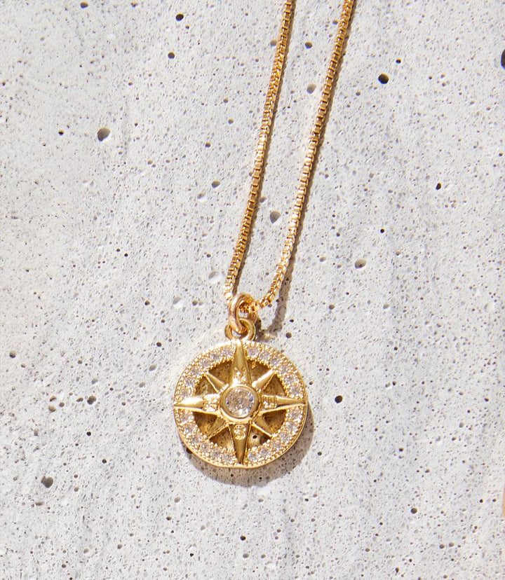 Cutout Sunburst Necklace in 14k and 18k gold fill with intricate sunburst pendant and sparkling center stone on a 16-inch chain.