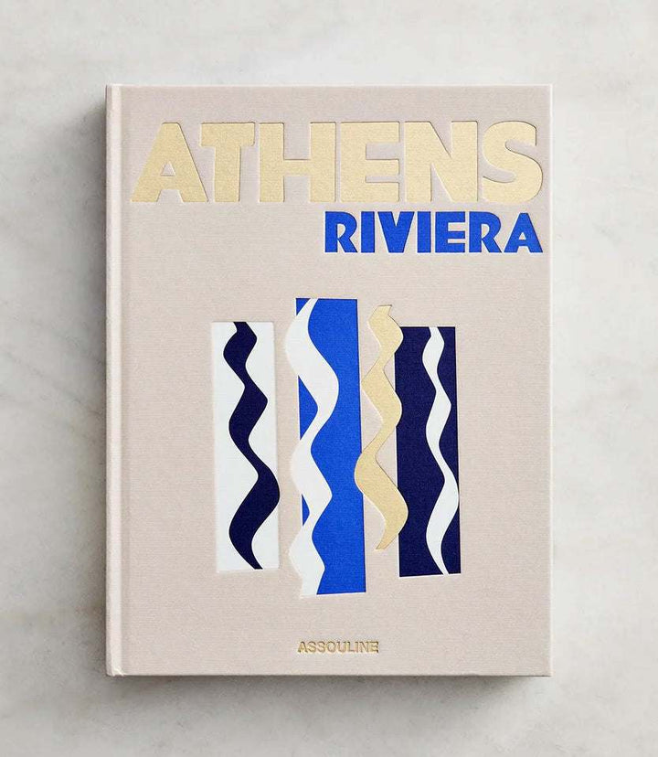 Softcover book titled Athens Riviera with abstract wave patterns in blue, gold, and navy on the cover