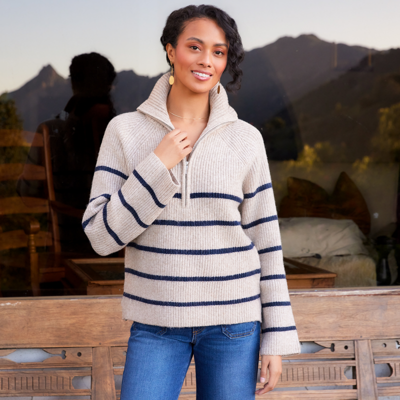 woman wearing a stripe half zip sweater