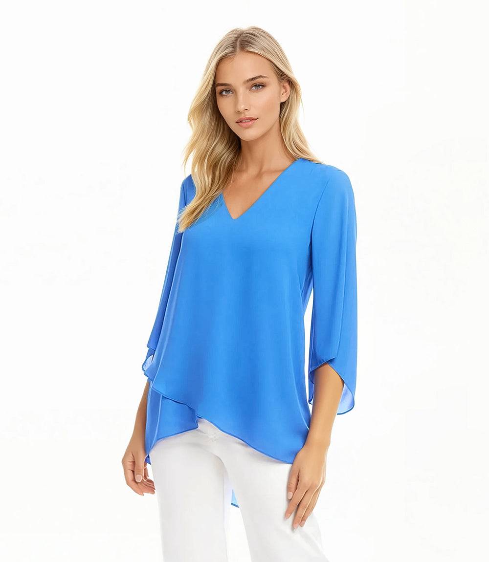 Woman wearing blue silky crepe Bracelet Sleeve Asymmetric Top with V-neck and layered asymmetrical hem