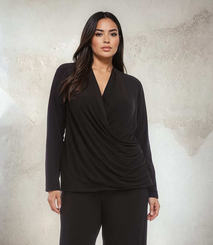 Plus size black travel jersey top with drape front crossover and long sleeves