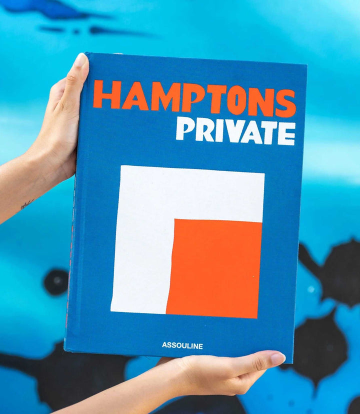 Hamptons Private coffee table book with blue cover and bold orange and white text, showcasing luxury Hamptons lifestyle.