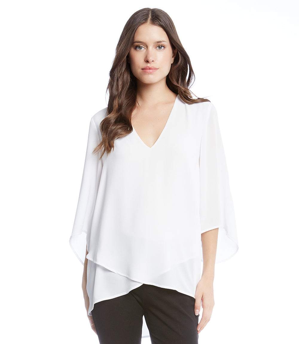 Petite size white bracelet sleeve asymmetric top with layered hem and V-neck on model