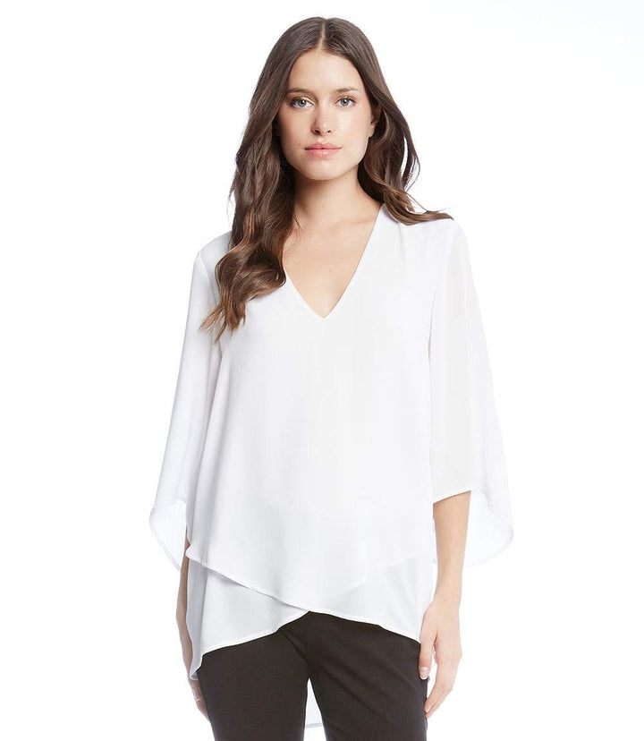 Petite size white bracelet sleeve asymmetric top with layered hem and V-neck on model
