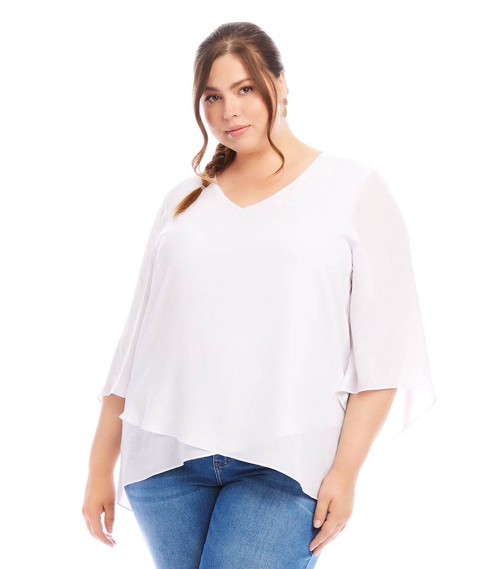 Plus size white bracelet sleeve top with V-neck and layered asymmetric hem in silky crepe fabric