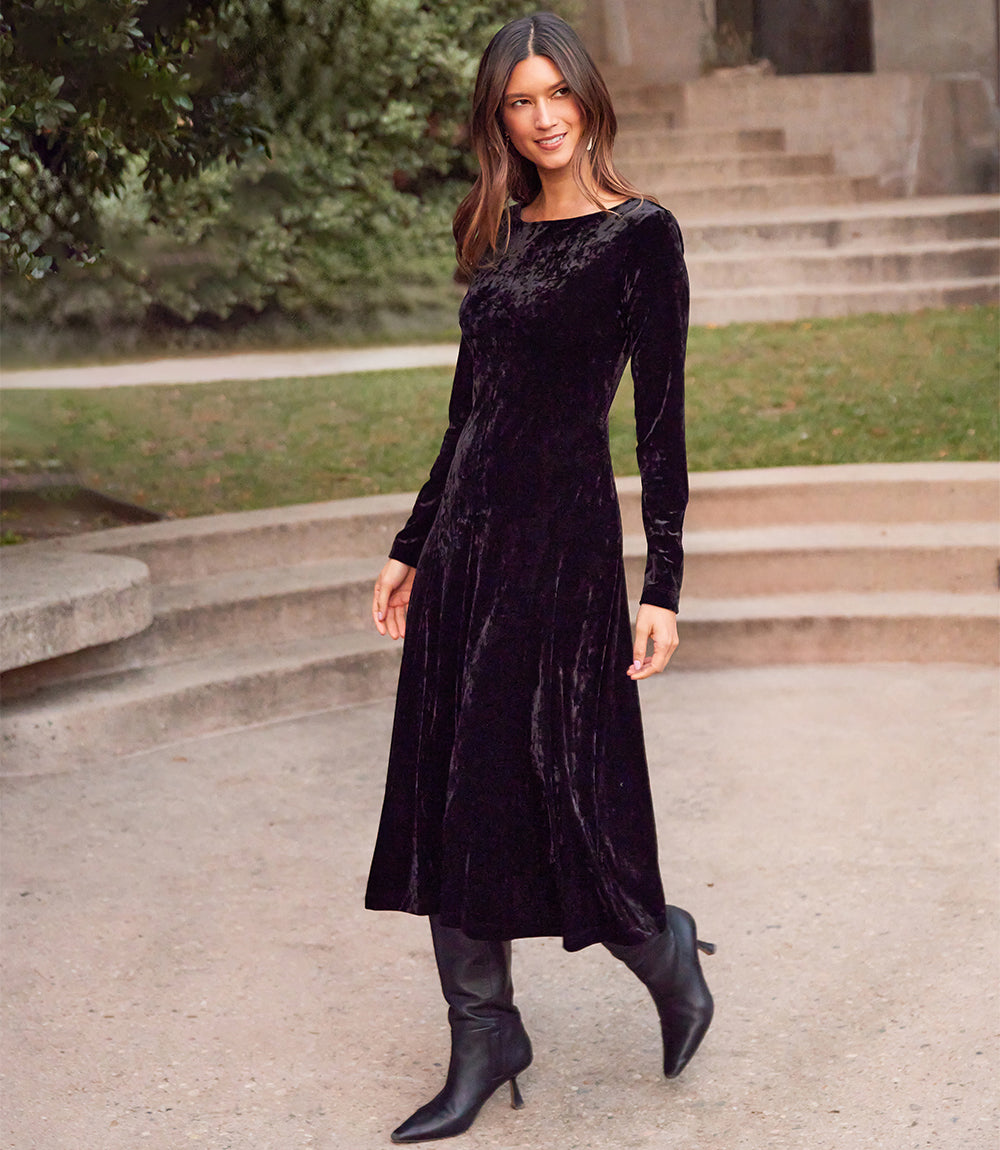 Woman wearing Kate Long Sleeve velvet midi dress in black outdoors on stone steps