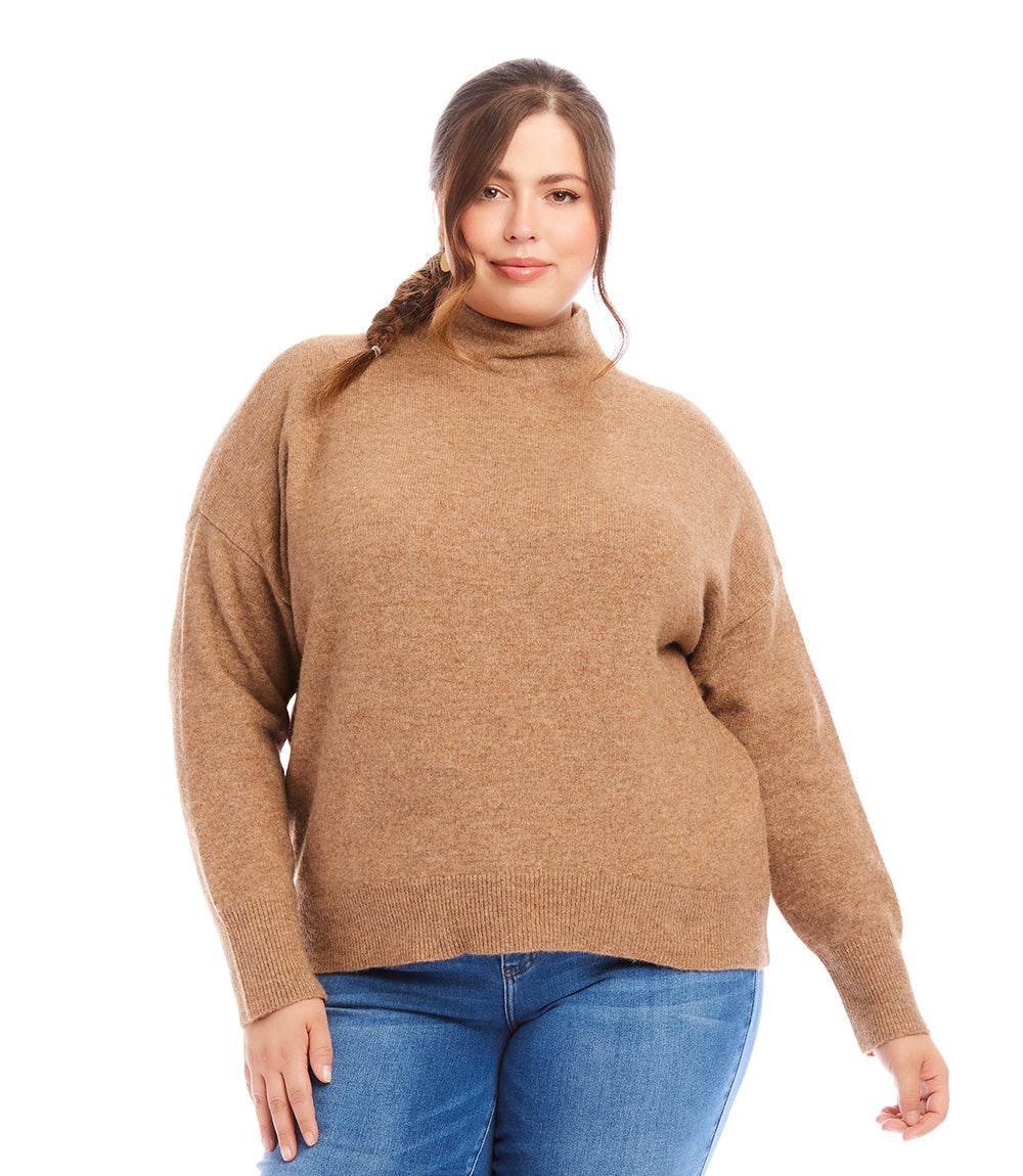 Plus size mock neck sweater in brown with a relaxed fit, worn with blue jeans, cozy and stylish for everyday wear