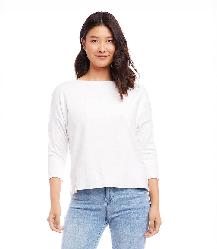 Woman wearing white boatneck top with 3/4 sleeves made of hemp organic cotton blend