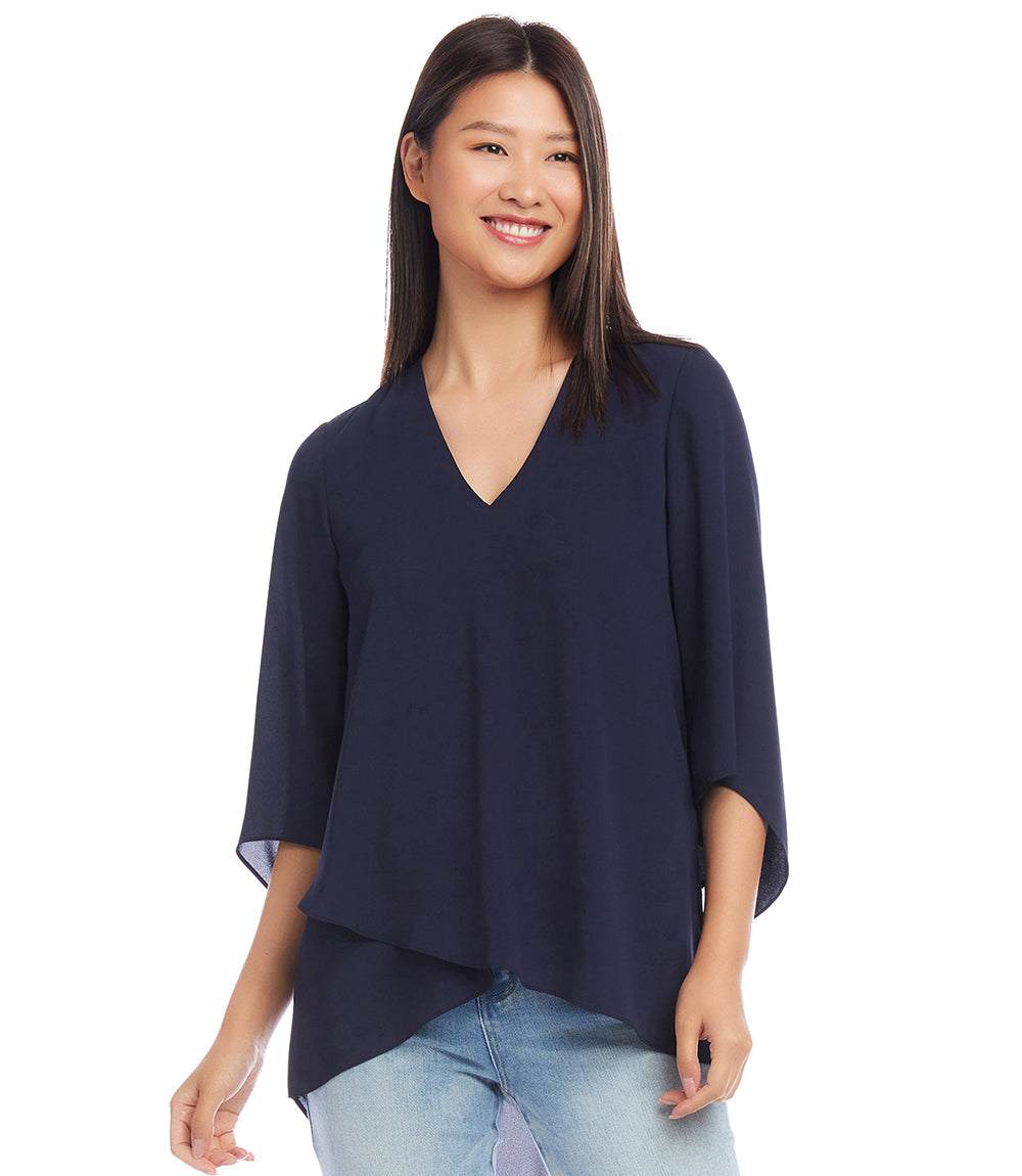 Woman wearing navy blue Bracelet Sleeve Asymmetric Top with V-neck and layered asymmetrical hem