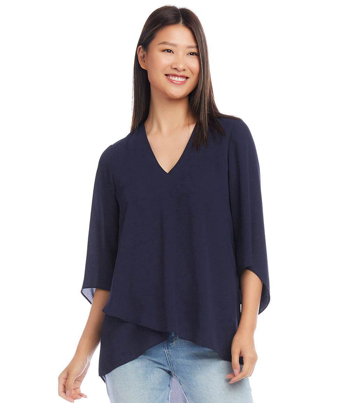 Woman wearing navy blue Bracelet Sleeve Asymmetric Top with V-neck and layered asymmetrical hem