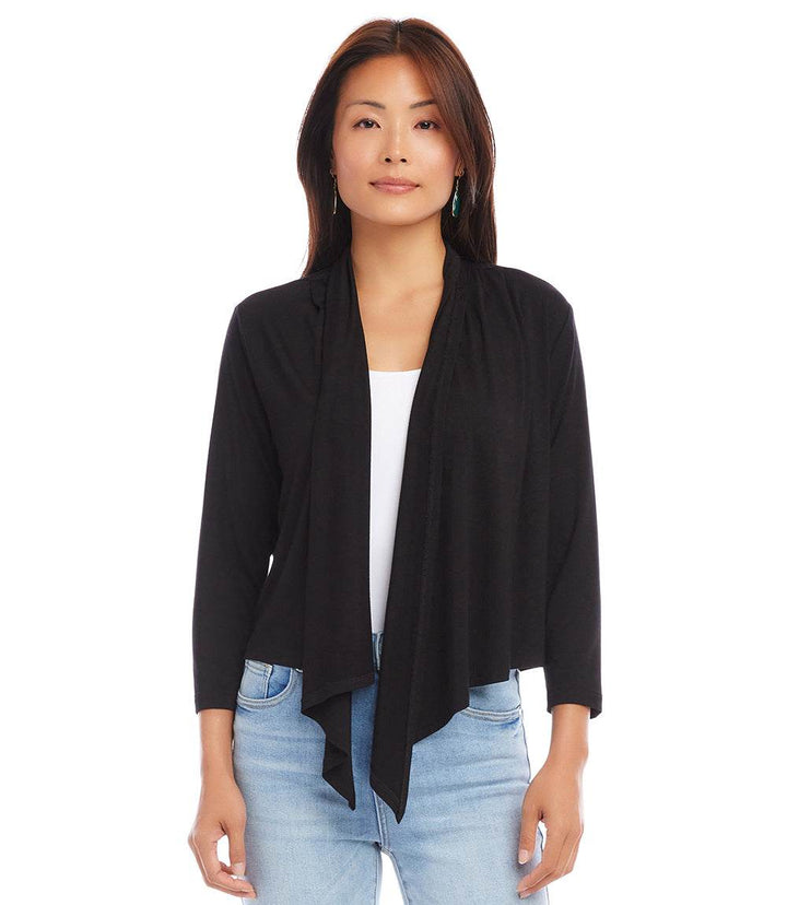 Woman wearing black Calli Cardigan with draped front and 3/4 sleeves over white top and jeans