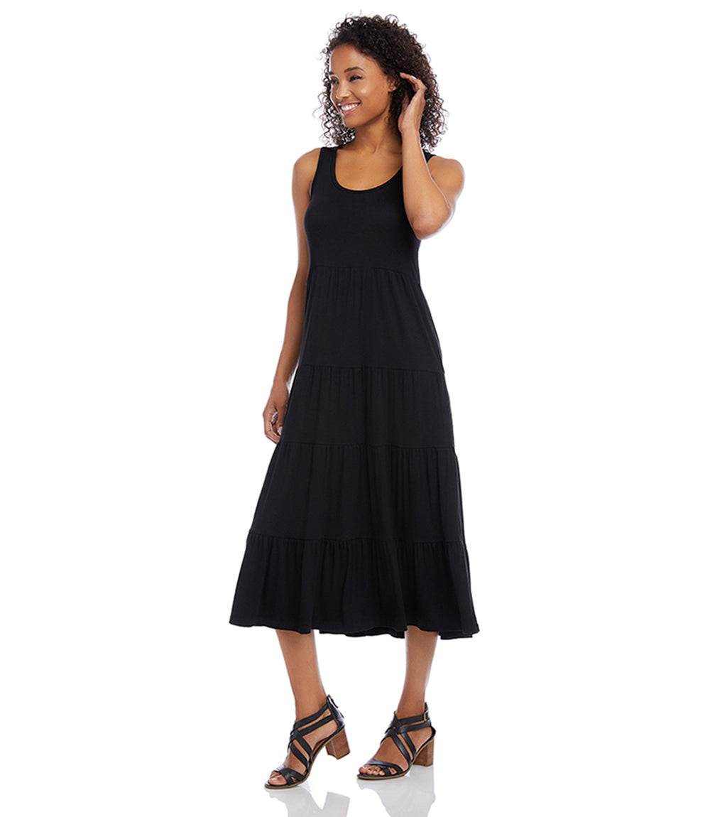 Black sleeveless tiered midi dress with scoop neckline and flouncy hem on model