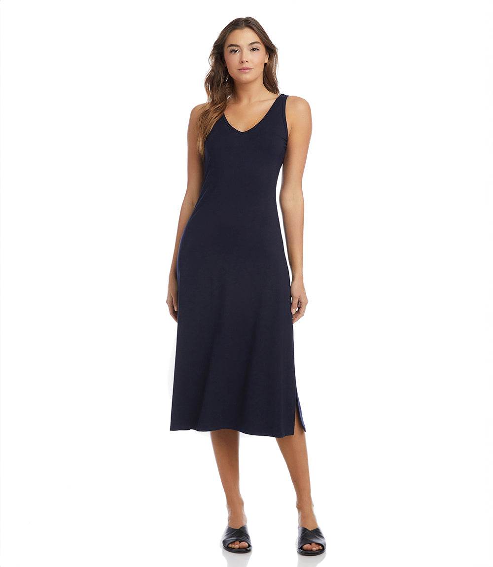 Woman wearing navy Brigitte Midi Dress with double V-neck and left side slit
