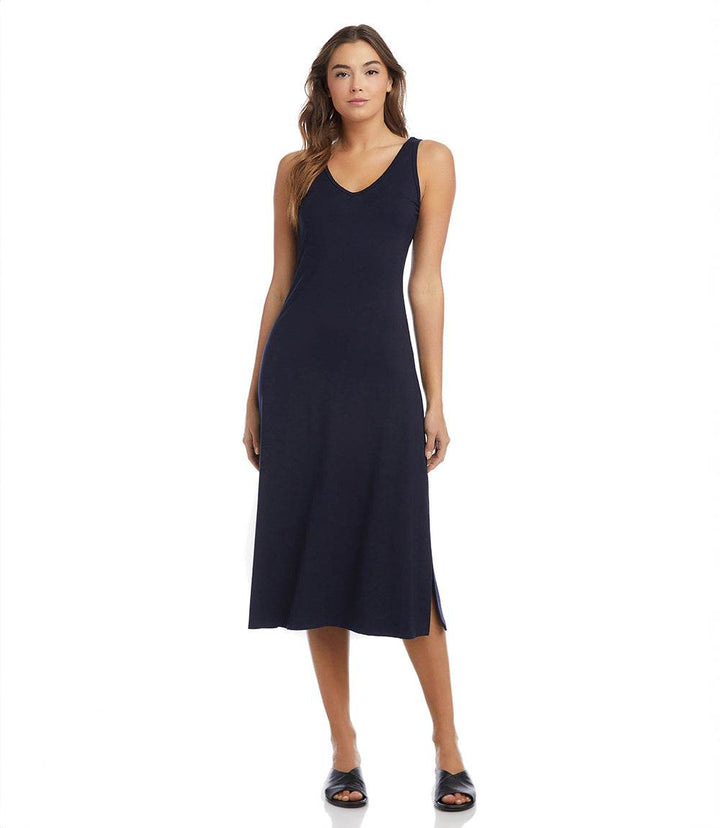 Woman wearing navy Brigitte Midi Dress with double V-neck and left side slit