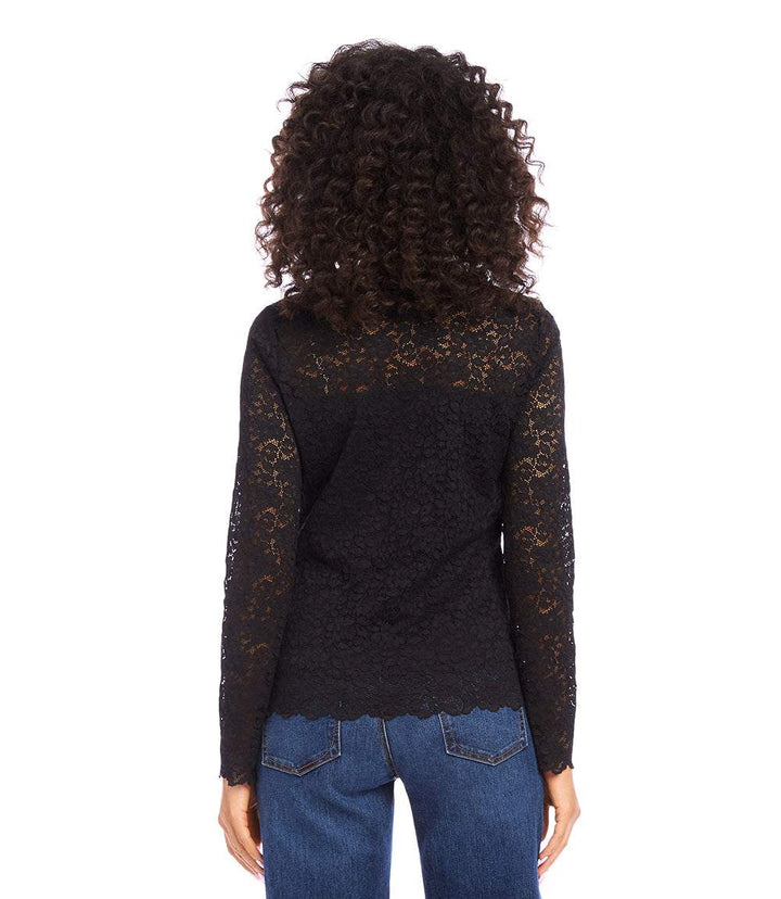 Woman wearing black scalloped lace top with sheer long sleeves and crew neck seen from back