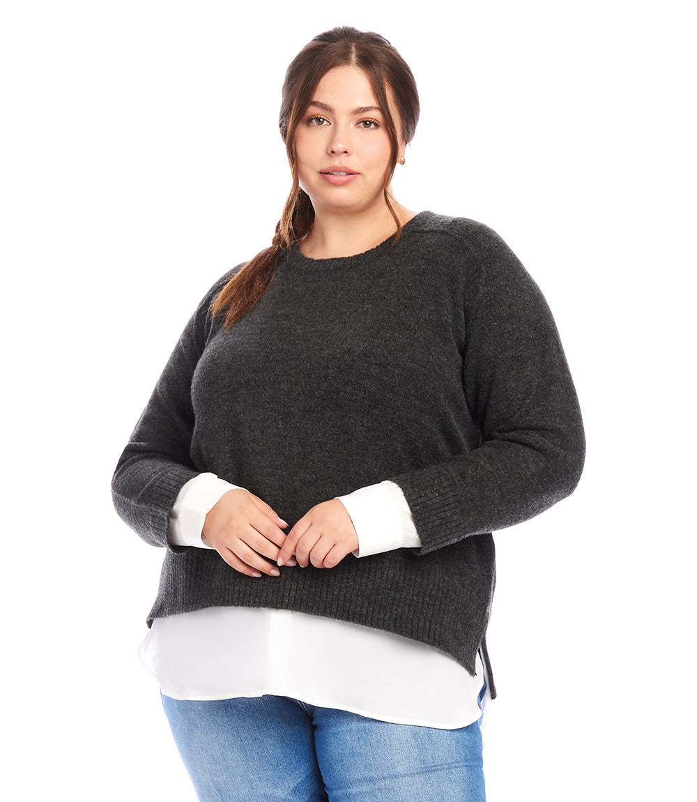 Plus size layered crewneck sweater in charcoal with contrast shirttail hem worn with blue jeans